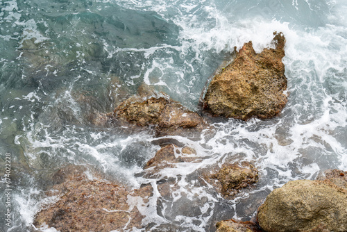 flowing sea water and rocks on the Mediterranean coast natural water background