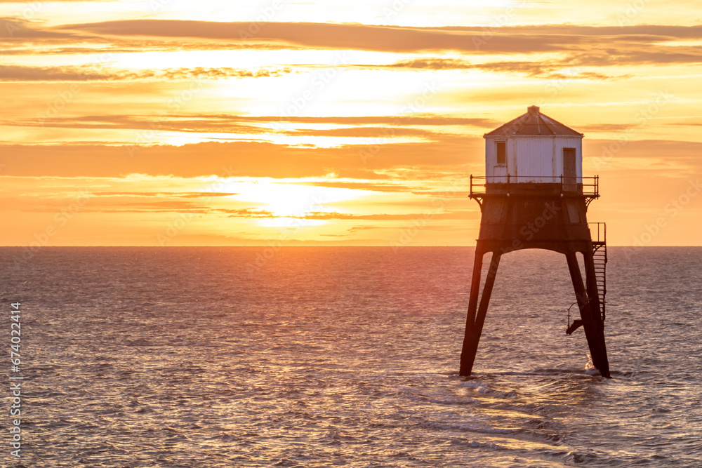 sunrise over a old lighthouse in the sea, Dovercourt low lighthouse, built in 1863 and discontinued in 1917 and restored in 1980 the 8 meter lighthouse is still a iconic sight, October 2023 sunrise over a old lighthouse in the sea, Dovercourt low lighthouse, built in 1863 and discontinued in 1917 and restored in 1980 the 8 meter lighthouse is still a iconic sight, October 2023