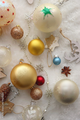 Various colorful Christmas oranments and white faux fur blanket. Top view. photo