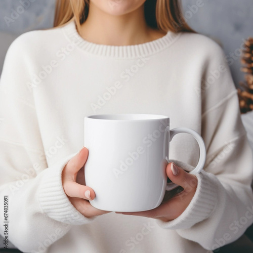 Girl is holding white mug in hands. Blank 11 oz ceramic cup