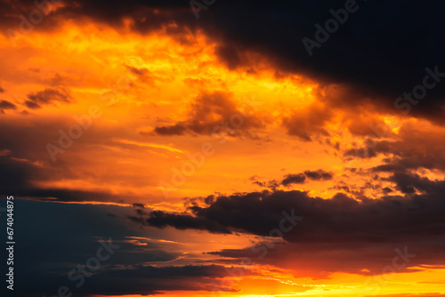 Valokuva Dramatic sky at sunset, dangerous heavy black orange color clouds in sky, abstra
