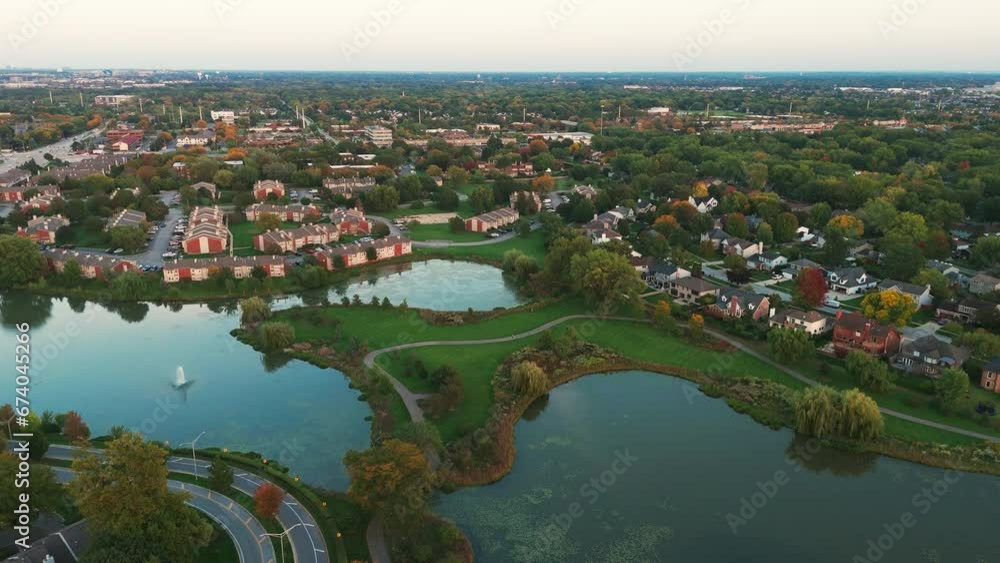 Above wide aerial view. Residential houses in suburbs near city in the evening Above wide aerial view. Residential houses in suburbs near city in the evening