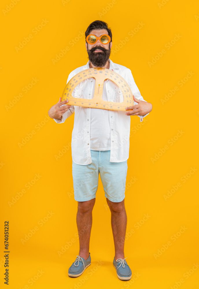 man with geometry protractor in studio. man hold geometry protractor on background. man with geometry protractor in studio. man hold geometry protractor on background.