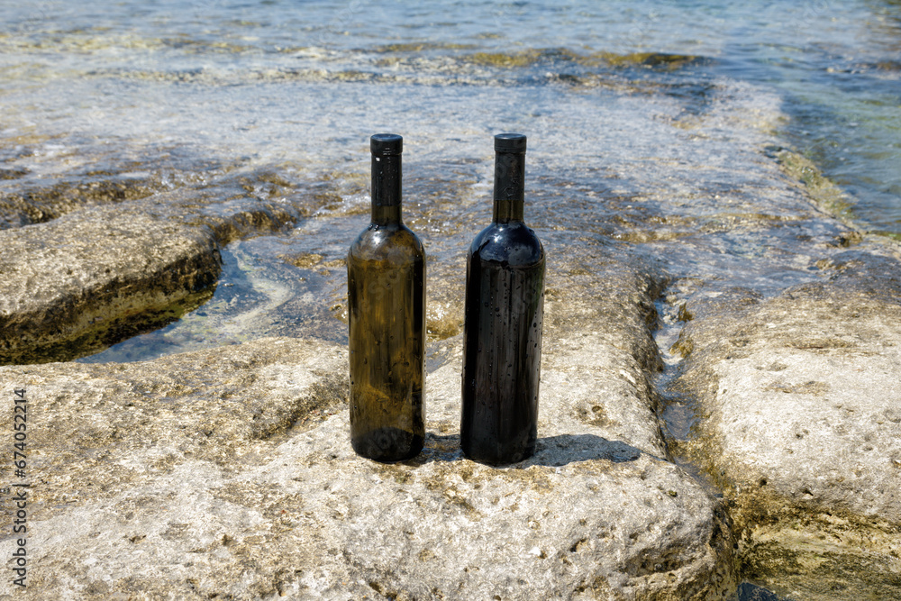 Two bottles of wine on the shore. Two bottles of wine on the shore.