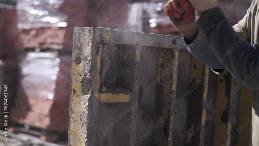 worker at a construction site breaks concrete with a hammer worker at a construction site breaks concrete with a hammer