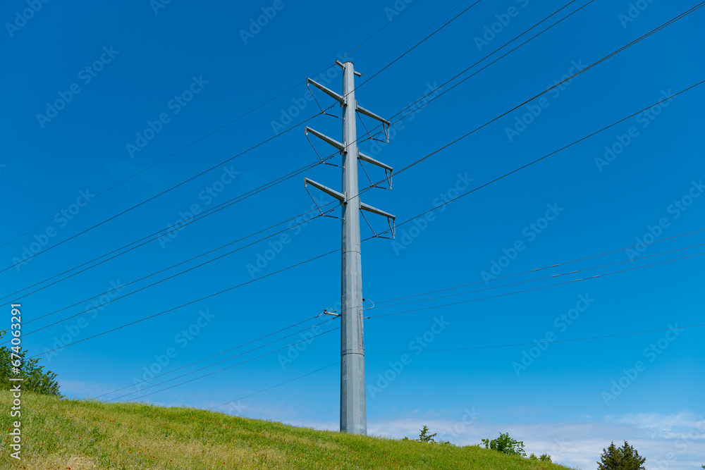 powering pylon utility. electricity power lines. pylon producing energy. voltage transmission on electric tower. high voltage powerline. powerful substation. electricity provider on hill