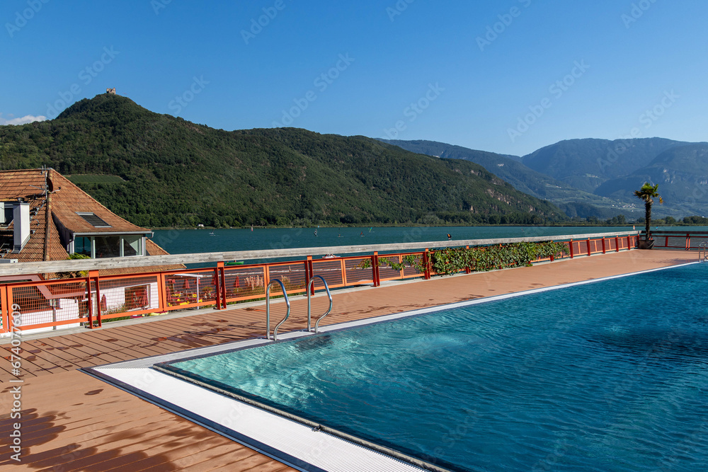 Fototapeta premium Kaltern, South Tyrol, Italy 05 September 2023 Lido and Lake Caldaro Kalterer See on sunny summer day