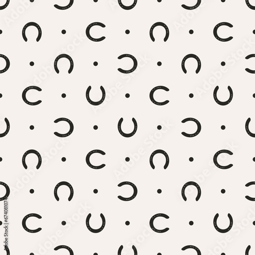 Vector illustration seamless texture composed with horseshoes prints photo