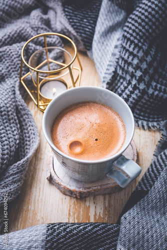 Fall season, leisure time, morning cocoa, sunday relax, hygge and still life concept. Cup of hot cocoa with warm knitted scarf and sweater