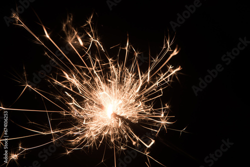 sparkler on black background at new years eve or sylvester photo