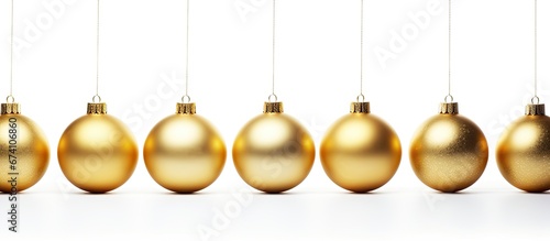 White background adorned with shimmering gold Christmas ornaments a magical time of year