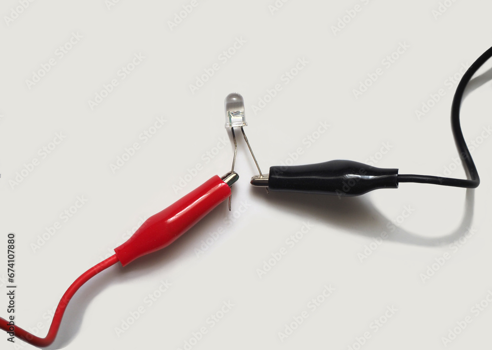 LED attached to red and black wires. Light-emitting diode or LED on a white background. LED attached to red and black wires. Light-emitting diode or LED on a white background.