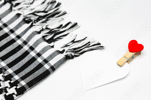 Free text space in the shape of a heart and traditional head scarf keffiyeh used in the Middle East and the Arab world on white background. photo