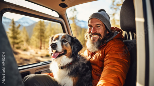 happy dog with owner sitting in their camper van photo