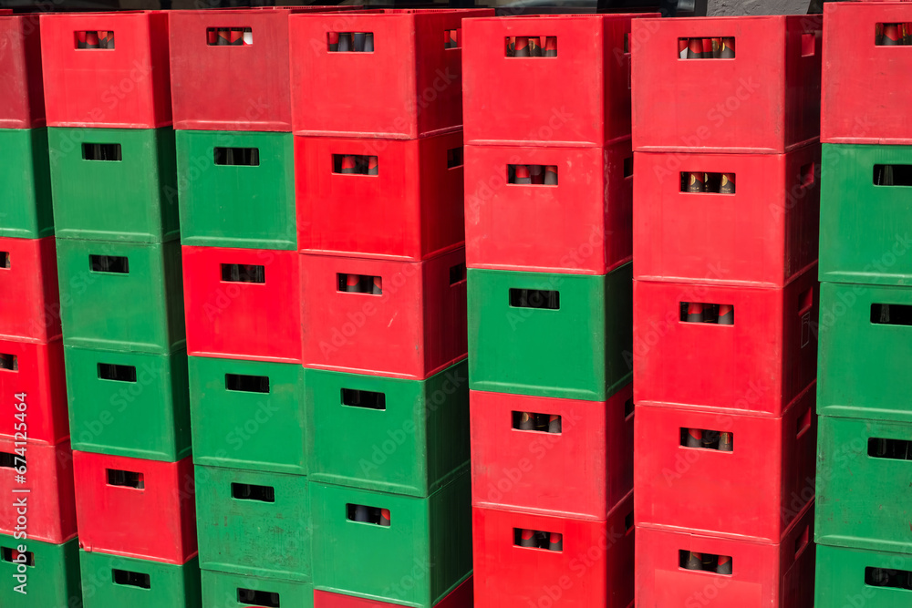 green and red beer crates with empty bottles