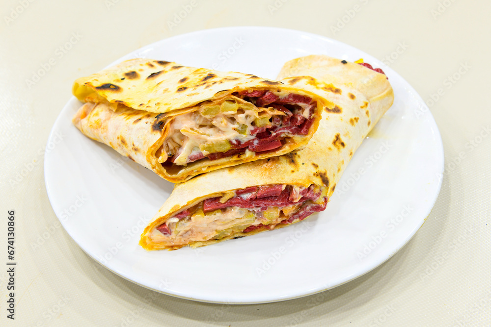 Lavash doner kebab ( zurna doner durum )  or shawarma sliced in plate isolated.  Tavuk Et Doner Durum. Hatay usulu tavuk doner durum. 