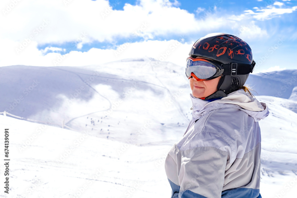 Active senior experienced mature women in winter overalls,ski mask on snow hill at high Carpathian mountains at alpine ski sport resort,nature landscape,Ukraine,Europe