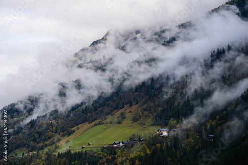 mountain landscape in the austrian alps with clouds and fog