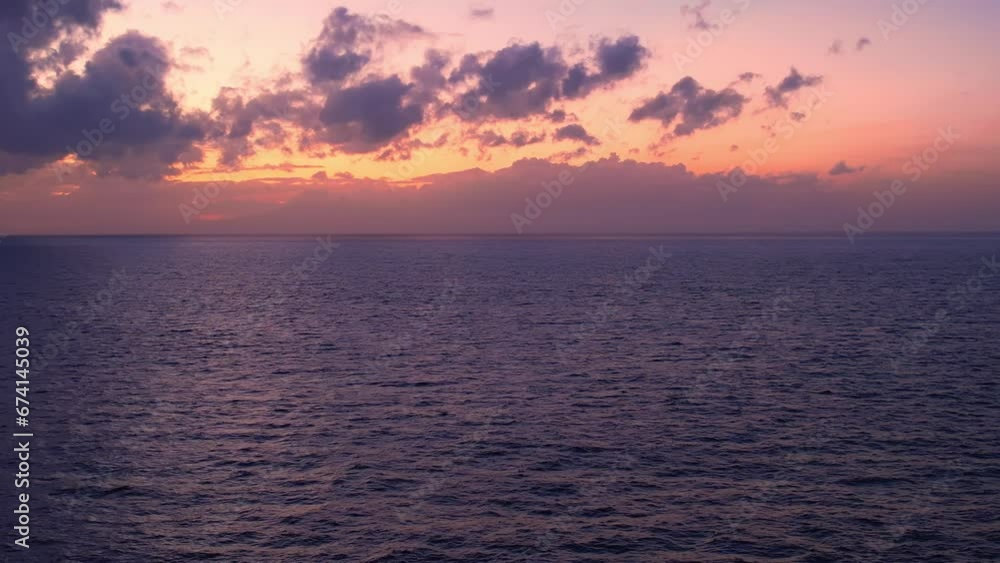 Tropical golden sunset over ocean water aerial view. Sun setting reflection on seascape. No people drone shot. Calm waterscape at sunny dawn evening. Summer vacation. Tropic holiday on Bali. Tropical golden sunset over ocean water aerial view. Sun setting reflection on seascape. No people drone shot. Calm waterscape at sunny dawn evening. Summer vacation. Tropic holiday on Bali.