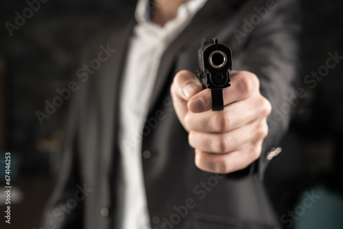 A man in a suit pointed a gun