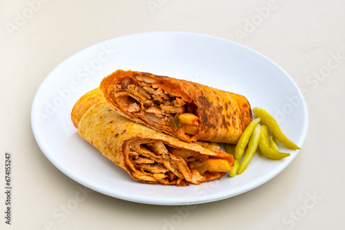 Lavash doner kebab ( zurna doner durum )  or shawarma sliced in plate isolated.  Tavuk Et Doner Durum. Hatay usulu tavuk doner durum.  photo