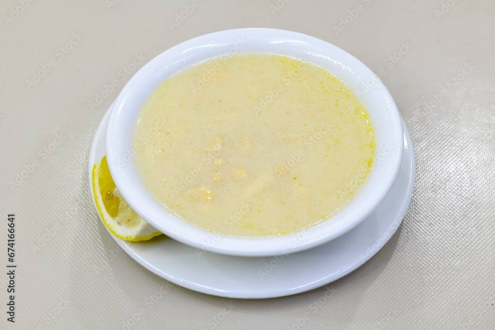 Homemade turkish soup Tavuk Suyu corbasi in a white ceramic soup plate.Turkish noodle chicken broth soup on a plate. Turkish meal (sehriyeli tavuk suyu corbasi) Homemade turkish soup Tavuk Suyu corbasi in a white ceramic soup plate.Turkish noodle chicken broth soup on a plate. Turkish meal (sehriyeli tavuk suyu corbasi)