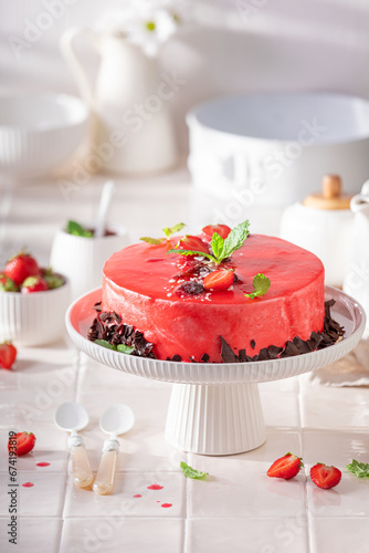 Homemade strawberry cake made of cream, glaze and fruits.