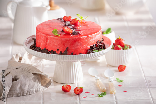 Sweet strawberry cake with red glaze and whipped cream.