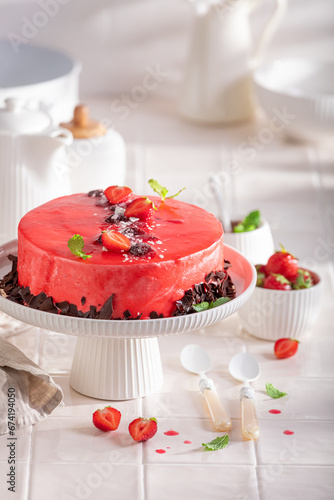 Tasty strawberry cake made of cream, glaze and fruits.