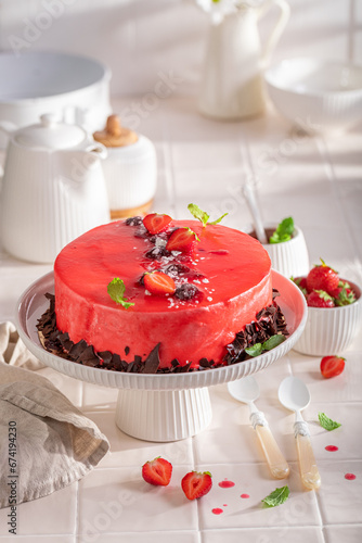 Tasty strawberry cake with cream and chocolate stripes.