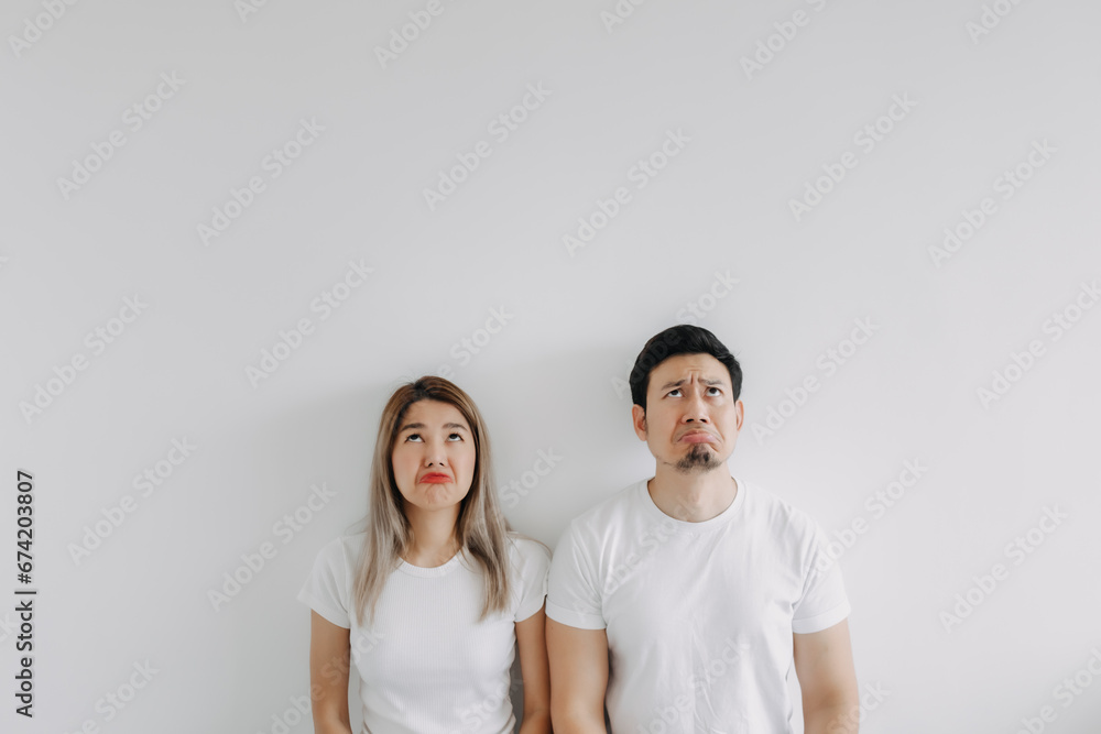 Advertisement copy space of boring face asian lover couple isolated on white. Advertisement copy space of boring face asian lover couple isolated on white.