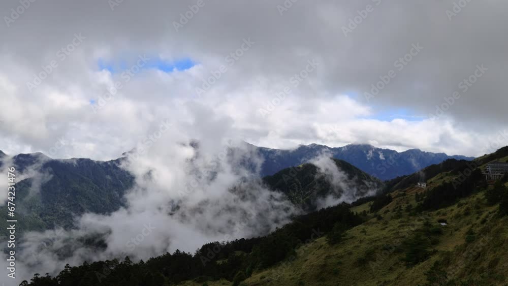 The astonishing cloudscape in front of your eyes. The surging, churning sea of clouds on the top of the green mountain and blue sky form a scenic scenery view. High quality video,Hehuanshan,Taiwn The astonishing cloudscape in front of your eyes. The surging, churning sea of clouds on the top of the green mountain and blue sky form a scenic scenery view. High quality video,Hehuanshan,Taiwn