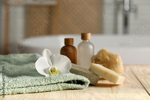 Composition with spa products on wooden table in bathroom, closeup