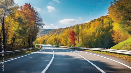 Asphalt concrete road with fallen leaves in autumn Amazing view with colorful autumn forest with asphalt mountain road.