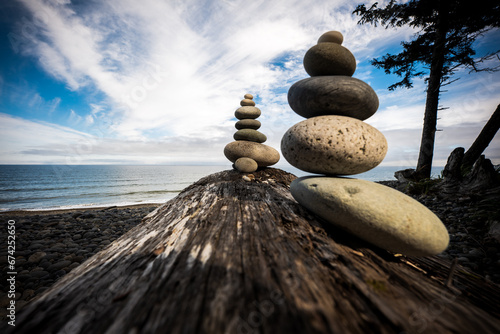 Photography Playing with stacking rocks on a log at Agate Beach, Haida Gwaii, British Columbia, Canada