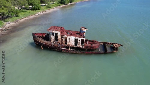 wreck boat in poluted caribbean sea in Dominican Republic photo