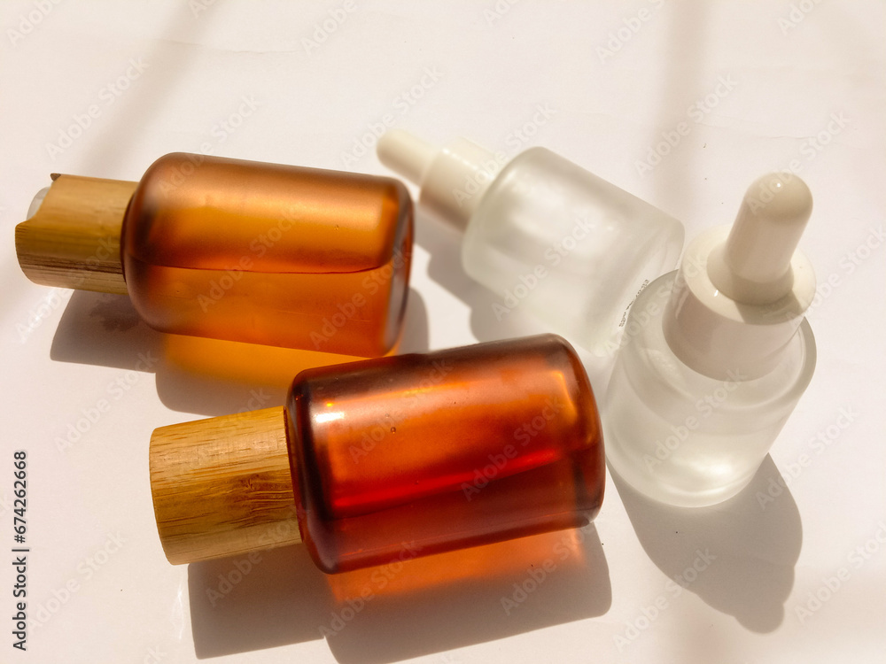 Brown and white skincare bottles on white background. Natural skincare concept Brown and white skincare bottles on white background. Natural skincare concept