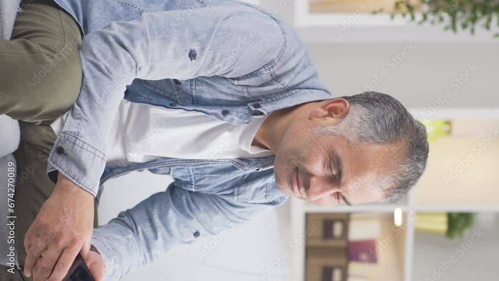 Vertical video of The man is breaking up with his wife on the phone and is upset. Vertical video of The man is breaking up with his wife on the phone and is upset.