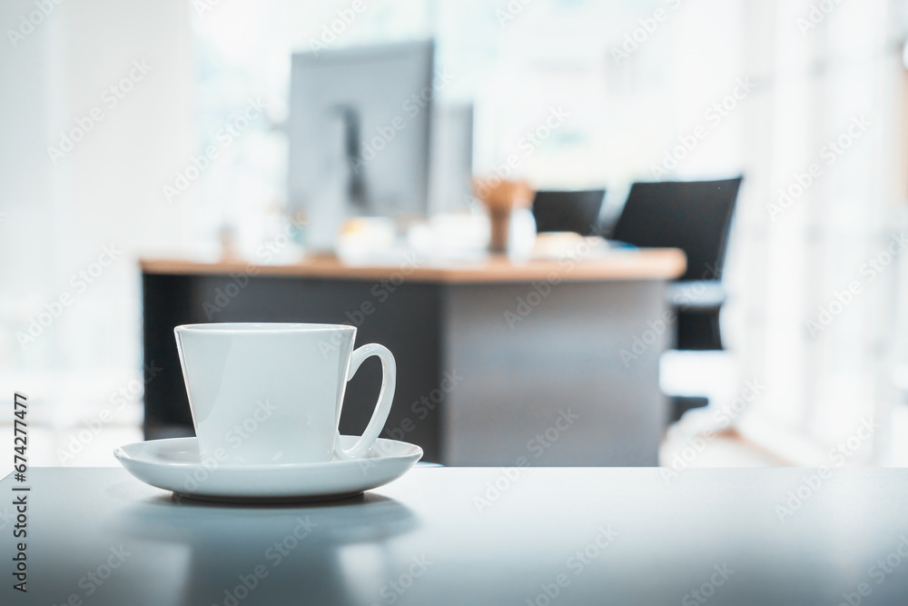 Coffee cup on office table with background of modern office. Coffee