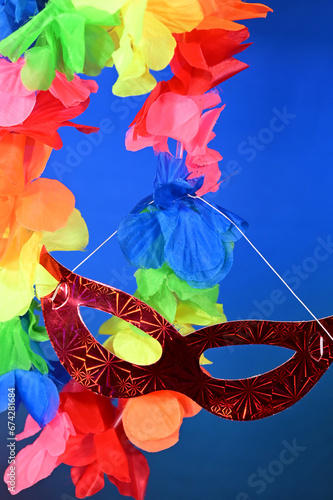 red carnival costume mask with colorful confetti and streamers joyful brazilian party celebration on white background with space for text photo