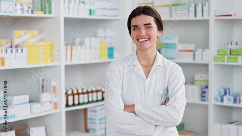Friendly pharmacist ready to advise patients or sell medication, laughing while standing in front of shelves of medicine. Happy, caucasian female doctor working at a pharmacy of a hospital or clinic. photo