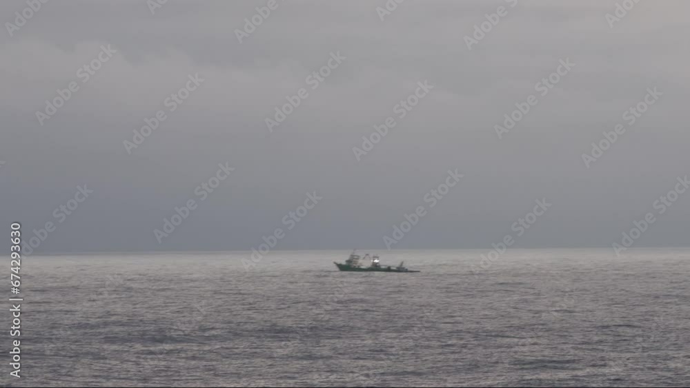 Lone small boat fishing calm open ocean waters at dawn Lone small boat fishing calm open ocean waters at dawn