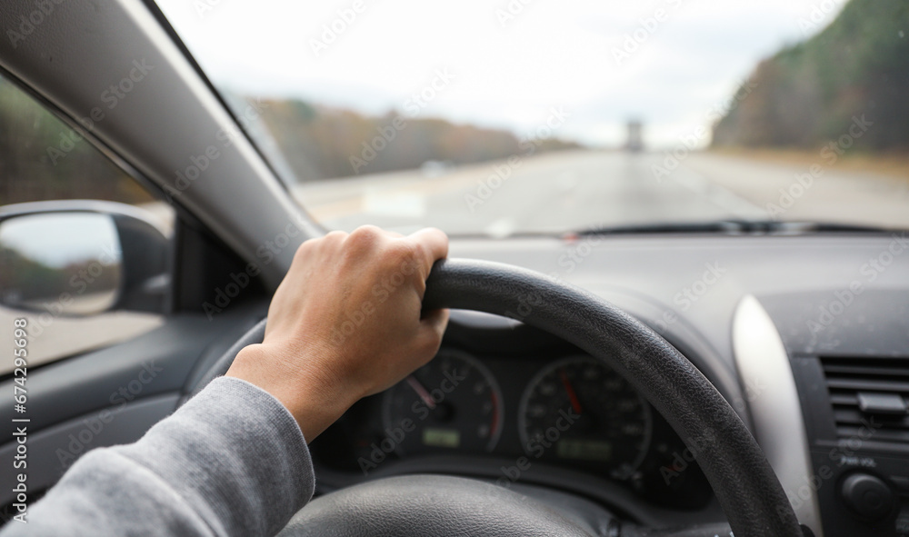 hands gripping a steering wheel, symbolizing control, focus, and safety while driving