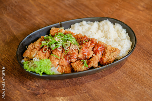 Chicken Katsu Curry is a dish of crispy chicken pieces served over rice with Japanese curry sauce.