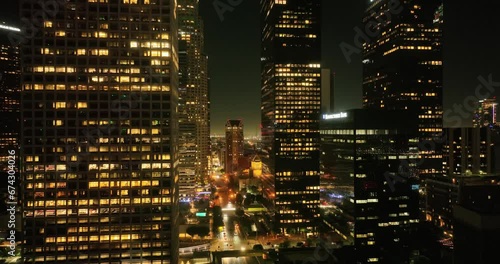 Night aerial view of downtown Los Angeles, California. Downtown Los Angeles at night from drone. Night illuminated flight over Los Angeles city downtown panorama. Los Angeles night buildings skyline.
