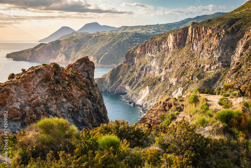 Eye-catching landscape of Lipari island at sunset time captured from the top of the mountain cliffs over the sea in Sicily, Italy photo