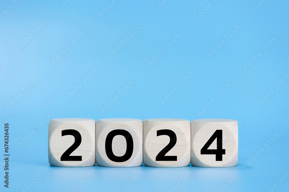 Wooden dice 2024 new year on blue background pastel. Wooden dice 2024 new year on blue background pastel.