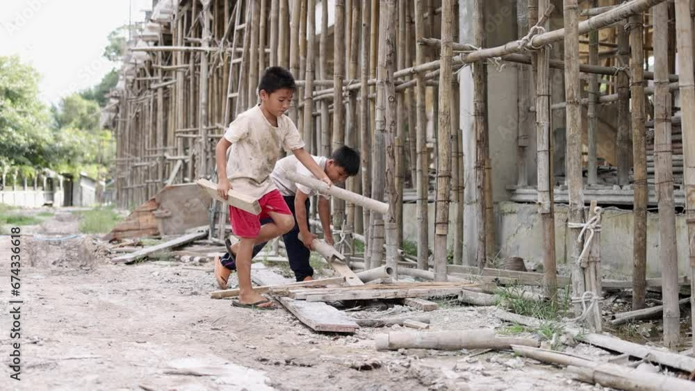 Poor children at the construction site were forced to work. Concept against child labor. The oppression or intimidation of forced labor among children. Human trafficking. Poor children at the construction site were forced to work. Concept against child labor. The oppression or intimidation of forced labor among children. Human trafficking.