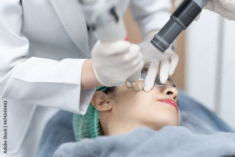 Woman receiving pico laser facial treatment in beauty Clinic. Woman receiving pico laser facial treatment in beauty Clinic.