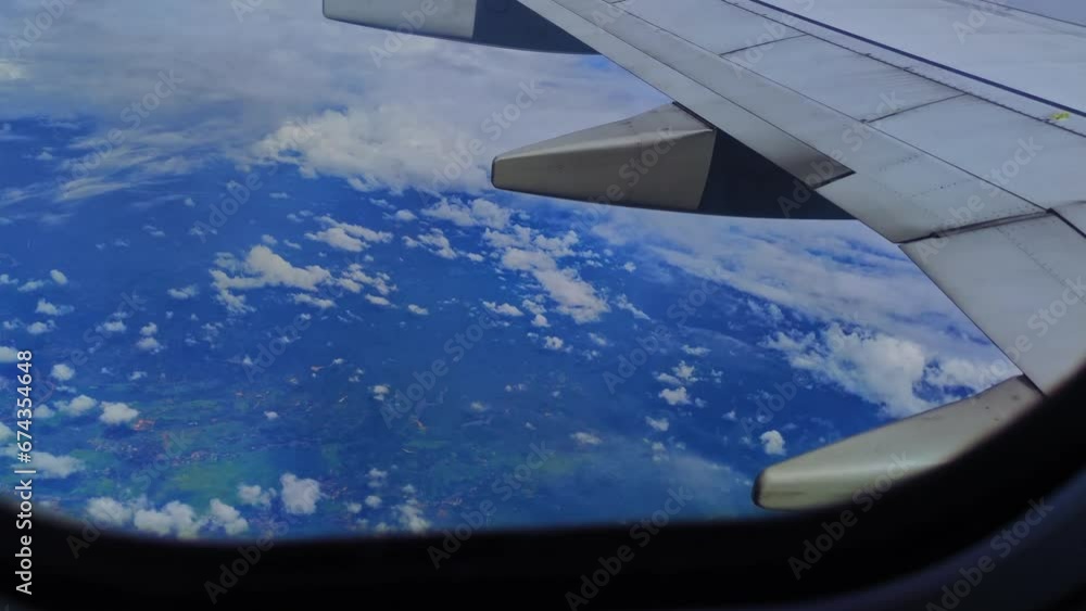 4K video aerial view of the cloudscape through an airplane window, vibrant natural scenery. Travel concept, traveler, trip, vacation, tourism, landscape. Background footage 4K video aerial view of the cloudscape through an airplane window, vibrant natural scenery. Travel concept, traveler, trip, vacation, tourism, landscape. Background footage